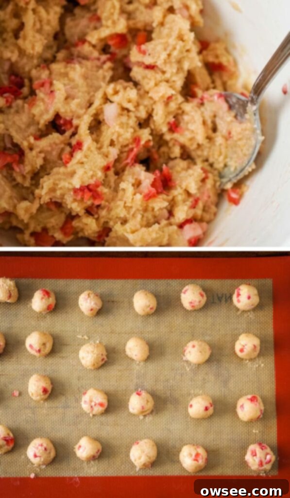 Easy Strawberry Cheesecake Truffles 7 Scooped portions of strawberry cheesecake truffle mixture on a parchment-lined baking sheet.
