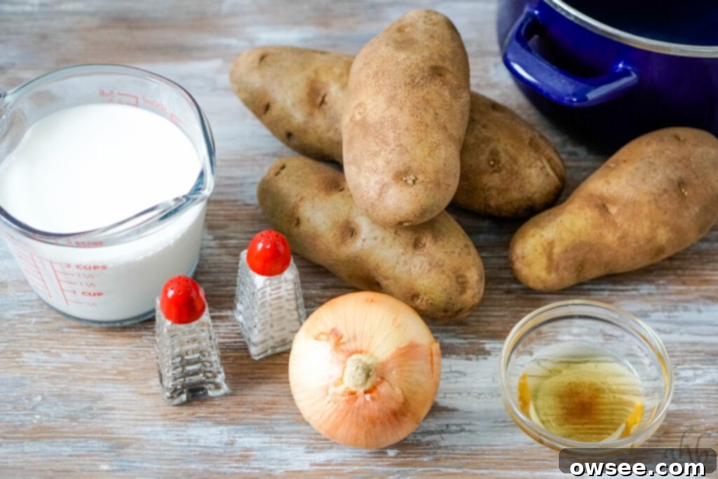 Effortless Four-Ingredient Potato Soup 4 A measuring of 2 cups of half and half, salt and pepper shakers, a yellow onion, a small bowl of bacon grease, 4 russet potatoes, and a large blue stockpot.