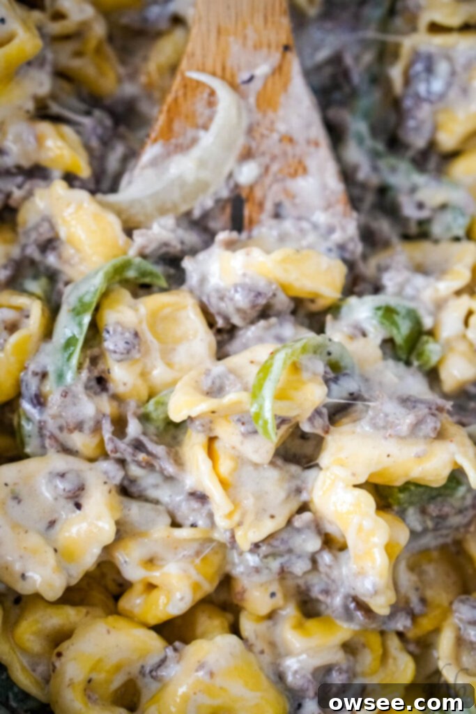 Philly Cheesesteak Filled Tortellini 7 Shredded provolone cheese is sprinkled over the creamy Philly Cheesesteak Tortellini mixture in the pan and stirred in to melt.