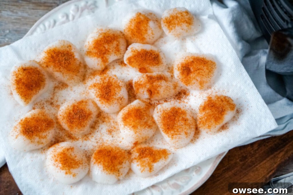 Crispy Air Fryer Scallops 6 Cajun seasoning and paprika are generously added to the dried scallops sitting on a paper towel, ready for air frying.